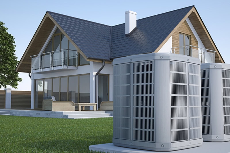 Two air conditioners installed outside of a home.