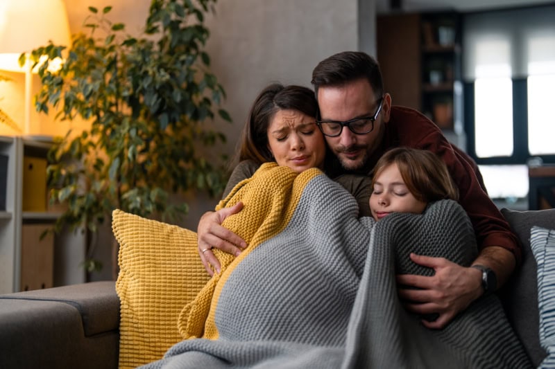 What Are the Signs that I Need a New Furnace? Family freezing at home because of an expensive heating during cold winter. Trying to warm themselves up.